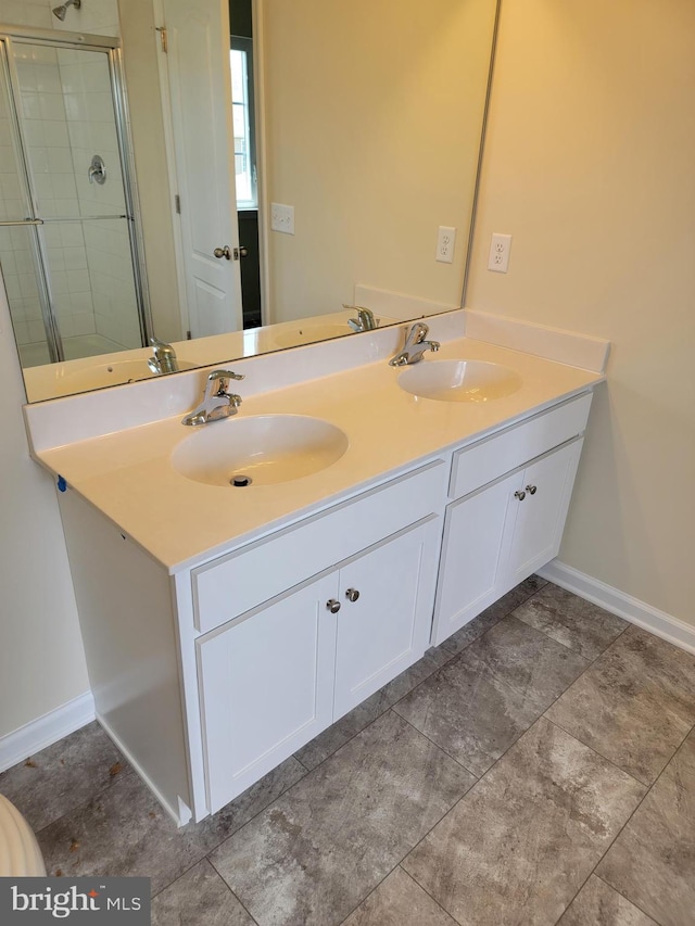 bathroom featuring vanity and a shower with shower door