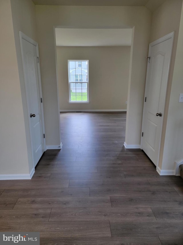 spare room with dark hardwood / wood-style flooring