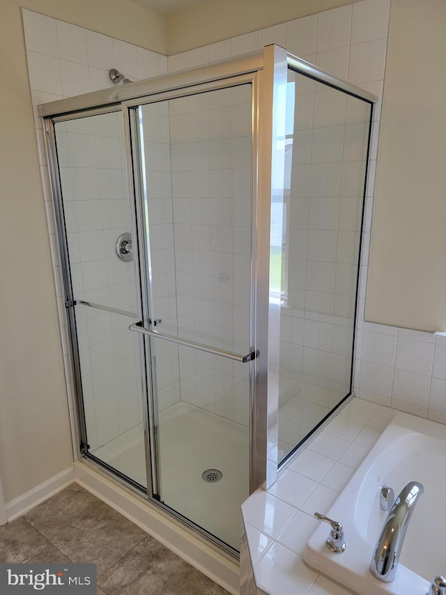 bathroom featuring shower with separate bathtub and tile patterned floors