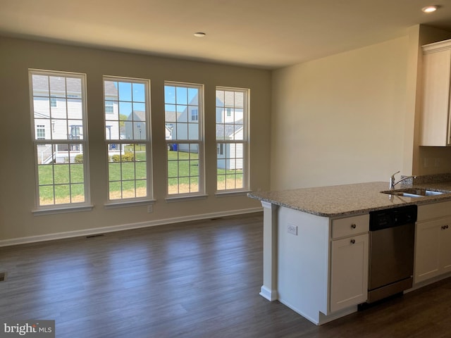 kitchen with sink, white cabinetry, dark hardwood / wood-style flooring, dishwasher, and light stone countertops