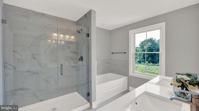 bathroom featuring separate shower and tub, plenty of natural light, and vanity