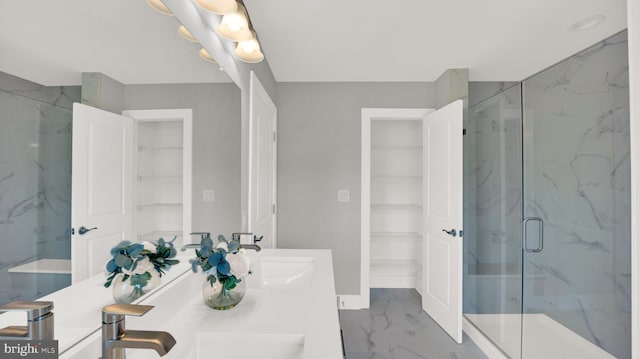 bathroom with double sink, tile flooring, large vanity, and a shower with door