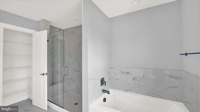 bathroom featuring tile flooring and shower with separate bathtub