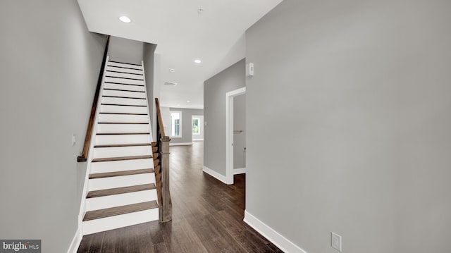 staircase featuring dark wood-type flooring