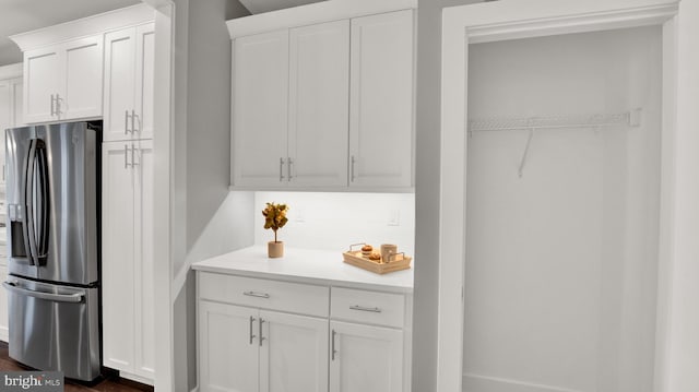 kitchen featuring stainless steel fridge with ice dispenser, dark hardwood / wood-style floors, and white cabinetry