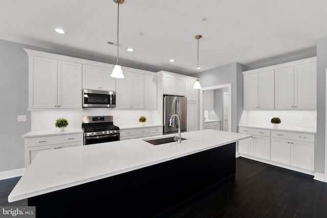 kitchen with white cabinets, hanging light fixtures, stainless steel appliances, and sink