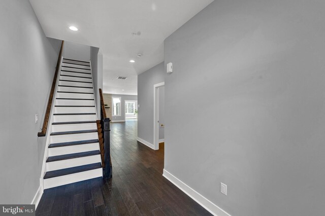stairway with dark wood-type flooring