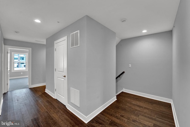 corridor featuring dark wood-type flooring