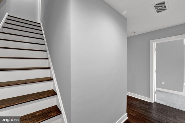 stairway featuring dark hardwood / wood-style floors