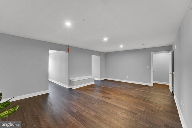 basement with dark hardwood / wood-style floors