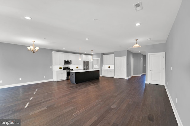 unfurnished living room featuring dark hardwood / wood-style floors and a chandelier