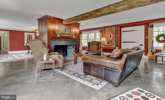 living room with concrete floors, plenty of natural light, and beamed ceiling