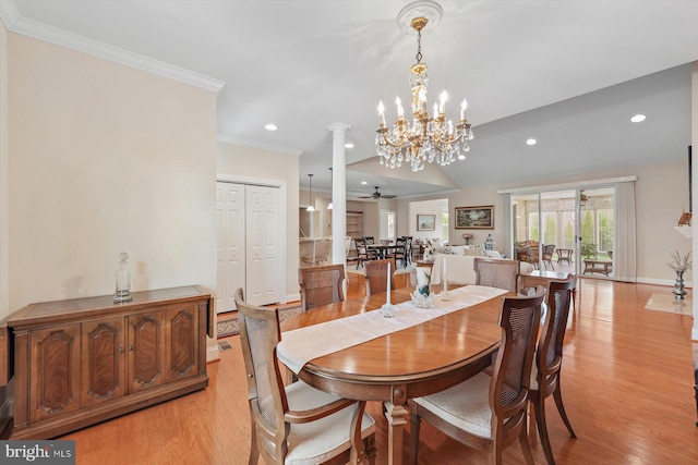 dining area with decorative columns, crown molding, light hardwood / wood-style floors, and ceiling fan with notable chandelier