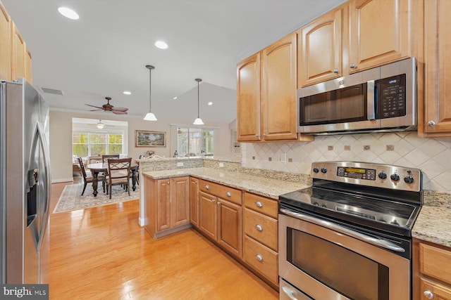 kitchen featuring kitchen peninsula, decorative backsplash, stainless steel appliances, pendant lighting, and light hardwood / wood-style floors