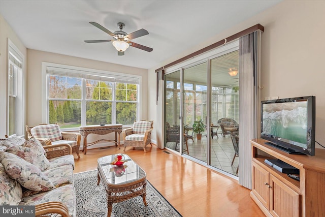 sunroom featuring ceiling fan