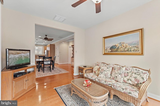 living room featuring ceiling fan and wood-type flooring