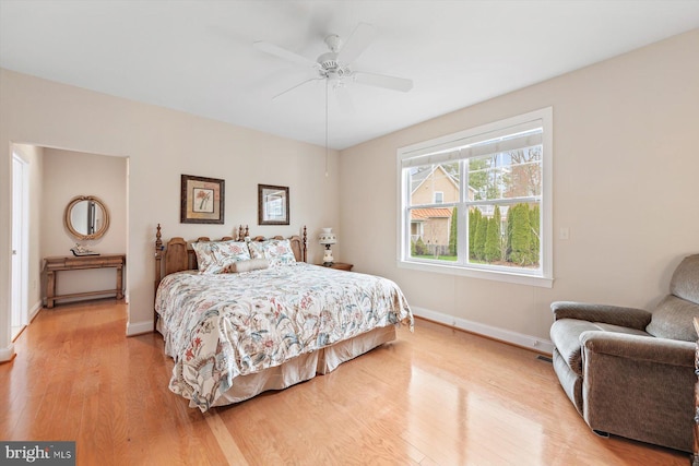 bedroom with light wood-type flooring and ceiling fan