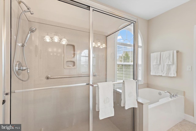 bathroom featuring tile patterned floors and independent shower and bath