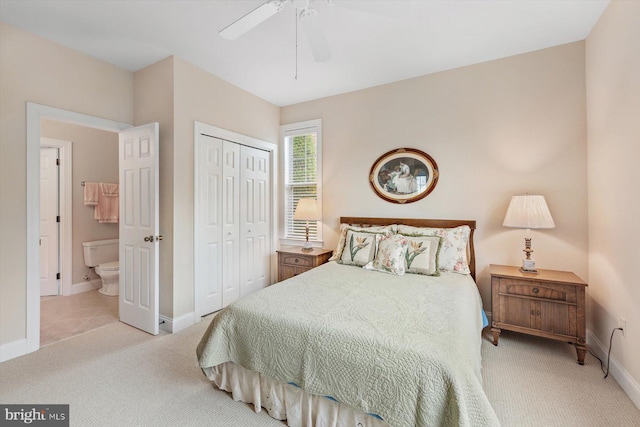 carpeted bedroom with connected bathroom, a closet, and ceiling fan