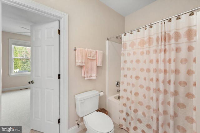 bathroom featuring shower / tub combo and toilet