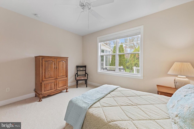 bedroom featuring ceiling fan and light carpet