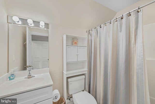 bathroom with vanity, toilet, and walk in shower