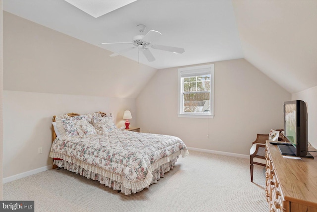 carpeted bedroom with ceiling fan and vaulted ceiling