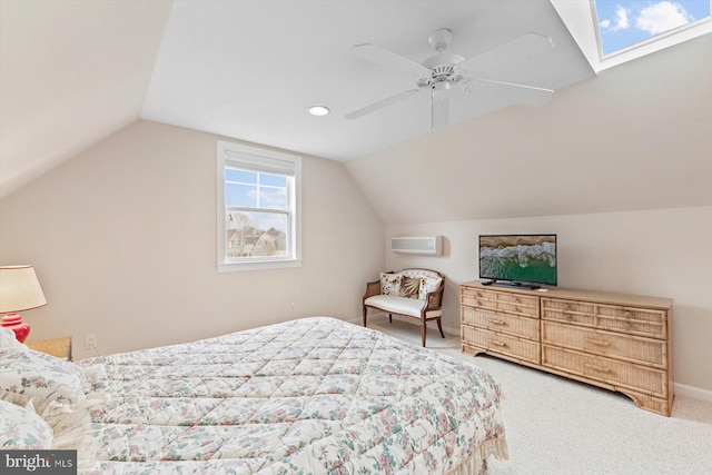 bedroom with carpet, a wall mounted air conditioner, lofted ceiling with skylight, and ceiling fan