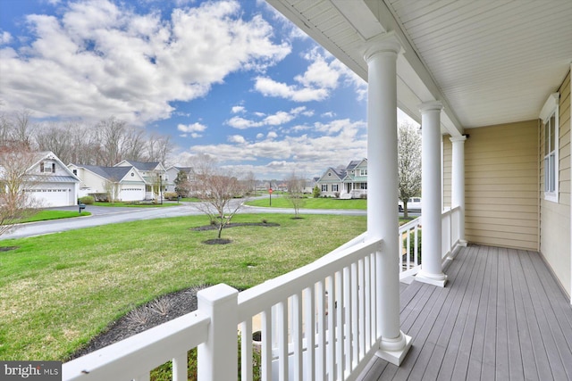 deck with covered porch and a yard