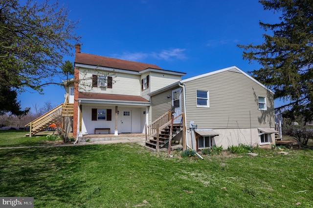 rear view of house with a yard