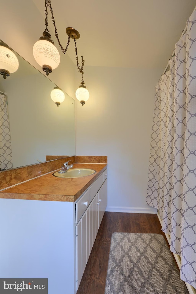 bathroom featuring oversized vanity and wood-type flooring