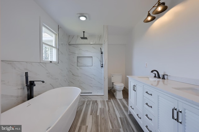 full bathroom featuring double sink vanity, toilet, shower with separate bathtub, and tile walls