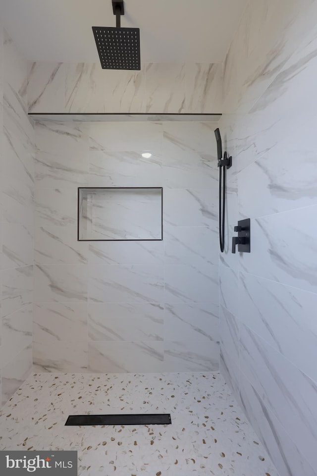 bathroom with a tile shower