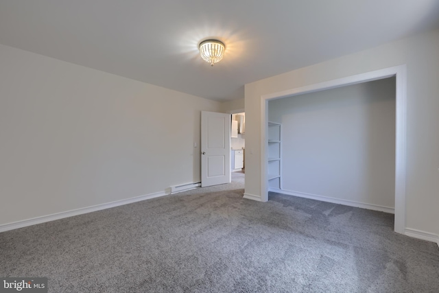 unfurnished bedroom with dark colored carpet and baseboard heating