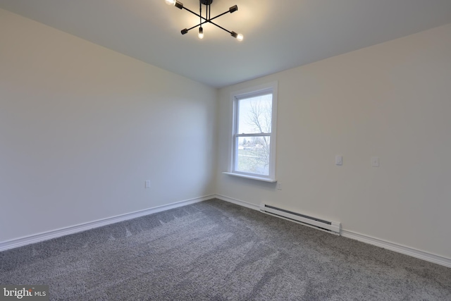 spare room featuring a chandelier, a baseboard radiator, and dark colored carpet