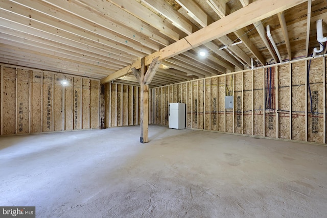 basement featuring white refrigerator