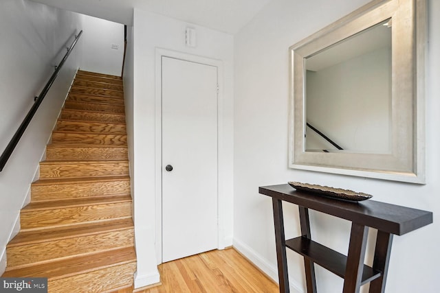 stairs featuring light hardwood / wood-style floors