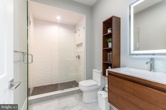 bathroom with tile patterned floors, vanity, toilet, and a shower with door