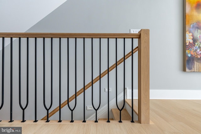 stairs featuring hardwood / wood-style floors