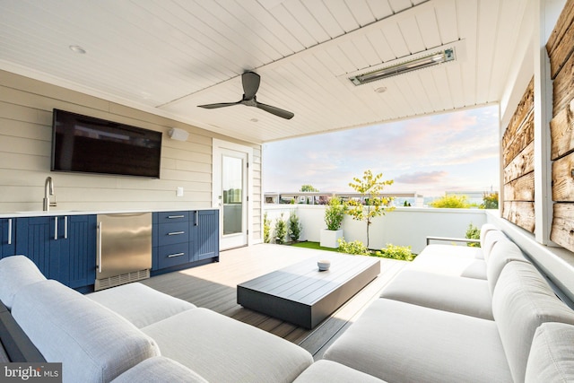 view of patio / terrace featuring an outdoor living space, ceiling fan, and a sink