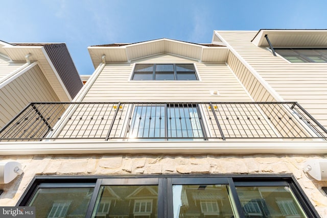 view of side of home featuring a balcony