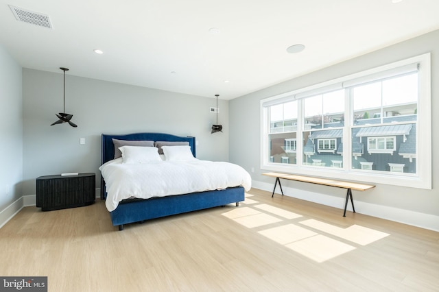 bedroom with recessed lighting, visible vents, baseboards, and wood finished floors