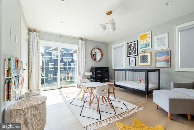 bedroom featuring access to exterior and wood finished floors