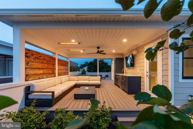 wooden terrace with an outdoor living space, area for grilling, ceiling fan, and a sink