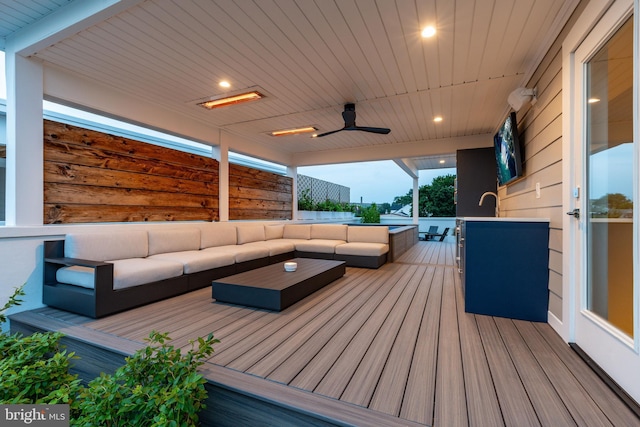 wooden terrace featuring an outdoor hangout area and ceiling fan