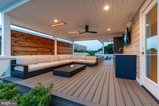 wooden terrace with outdoor lounge area and ceiling fan