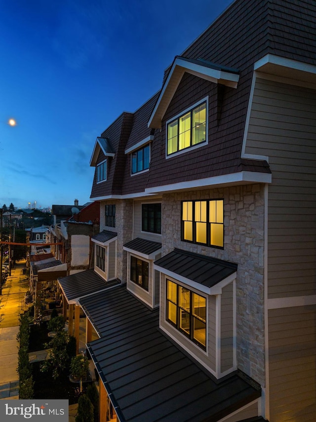 rear view of property featuring a standing seam roof and metal roof