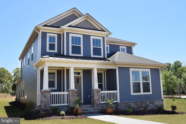 craftsman-style house with covered porch and a front lawn