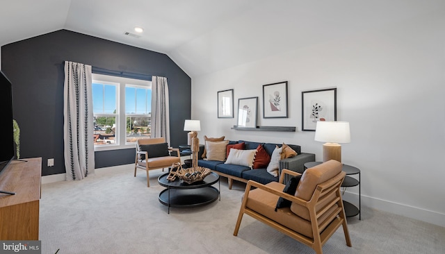 carpeted living room with vaulted ceiling