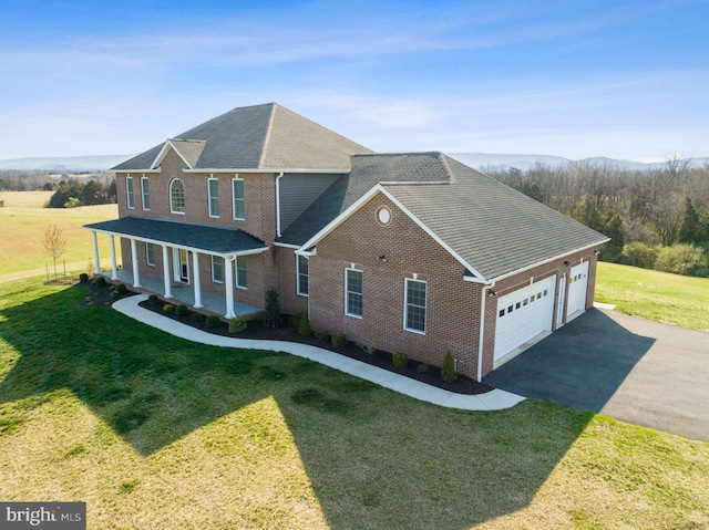 view of front of property featuring a front lawn and a garage